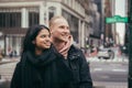 Happy young adult couple look to the side together standing on New York City street. Royalty Free Stock Photo