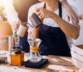 Happy young adult couple making breakfast and drinking coffee together in cozy home kitchen in morning at home. Preparing meal and Royalty Free Stock Photo