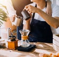 Happy young adult couple making breakfast and drinking coffee together in cozy home kitchen in morning at home. Preparing meal and Royalty Free Stock Photo