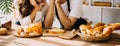 Happy young adult couple making breakfast and drinking coffee together in cozy home kitchen in morning at home. Preparing meal and Royalty Free Stock Photo