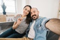 Happy young adult couple taking selfie photo after moving to new apartment Royalty Free Stock Photo