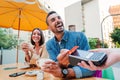 Happy young adult man paying the bill with a contactless credit card on a restaurant, bar or coffee shop. Handsome male Royalty Free Stock Photo