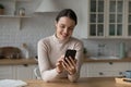 Happy young adult millennial girl chatting on mobile phone Royalty Free Stock Photo