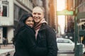 Happy young adult multicultural couple in love hugging and smiling on New York City street. Royalty Free Stock Photo