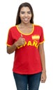 Happy young adult soccer fan from Spain with red jersey