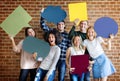 Happy young adults holding empty placard thought bubbles copyspa Royalty Free Stock Photo