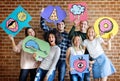 Happy young adults holding thought bubbles Royalty Free Stock Photo