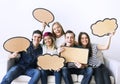 Happy young adults holding up copyspace placard thought bubbles