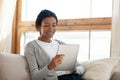 Happy young african american biracial woman using digital computer tablet. Royalty Free Stock Photo