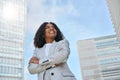 Happy young African American business woman standing in city feeling proud. Royalty Free Stock Photo