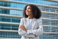 Happy young African American business woman standing in city looking away. Royalty Free Stock Photo