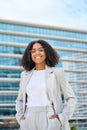 Happy young African American business woman standing in city, vertical portrait. Royalty Free Stock Photo