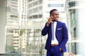 Happy young african american businessman with cell phone Royalty Free Stock Photo