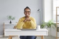 Happy young African American businesswoman sitting at working desk with laptop at home Royalty Free Stock Photo