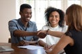 Happy young african american clients shaking hands with financial advisor. Royalty Free Stock Photo