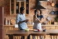 Happy young african american family couple having fun, preparing food. Royalty Free Stock Photo
