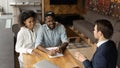 Happy young african american family couple talking with professional lawyer. Royalty Free Stock Photo