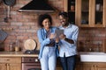 Happy young African American family couple using digital tablet. Royalty Free Stock Photo