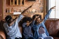 Smiling biracial parents with daughter dab dance