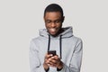 Happy young african american guy looking at cellphone screen. Royalty Free Stock Photo