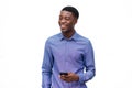 Happy young african american man with cellphone against isolated white background Royalty Free Stock Photo