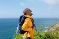 Happy young african american man hiking in nature with backpack Royalty Free Stock Photo
