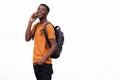 Happy young african american man standing by white wall talking on mobile phone Royalty Free Stock Photo