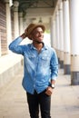 Happy young african american man walking with hat Royalty Free Stock Photo