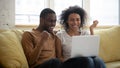 Happy young african american couple looking at laptop. Royalty Free Stock Photo