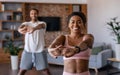 Happy young african american man and woman in sportswear doing stretching or warm up exercises Royalty Free Stock Photo