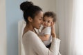 Happy African American mom embrace little baby toddler Royalty Free Stock Photo