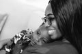 Happy young African American mother having fun with daughter child girl playing and hugging in bedroom at home Royalty Free Stock Photo