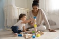 Happy young african american mother playing cubes with baby. Royalty Free Stock Photo