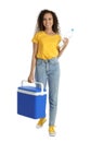 Happy young African American woman with cool box and bottle of water on white background Royalty Free Stock Photo