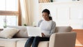 Happy young african american woman in headphones looking at laptop. Royalty Free Stock Photo