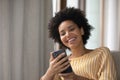 Happy young african american woman using cellphone. Royalty Free Stock Photo