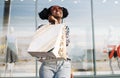 Happy American woman, with shopping bags shopping, fashionable woman enjoying shopping in the city on Black Friday Royalty Free Stock Photo