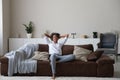 Calm biracial woman relax on cozy couch at home Royalty Free Stock Photo