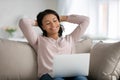 Happy biracial woman relax on couch using laptop Royalty Free Stock Photo