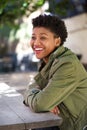 Happy young african american woman sitting outside Royalty Free Stock Photo