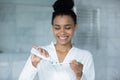 Happy young African American woman squeezing mint toothpaste Royalty Free Stock Photo