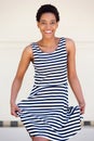 Happy young african american woman striped dress