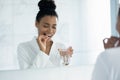 Happy young African American woman taking pill of vitamin Royalty Free Stock Photo