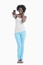 Happy young African American woman taking self portrait over white background Royalty Free Stock Photo