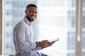 Happy young African business man using online app on tablet Royalty Free Stock Photo