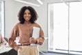 Happy young African business woman standing in office. Portrait. Copy space. Royalty Free Stock Photo