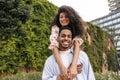 Happy young african couple posing looking at camera relaxing outdoors. Royalty Free Stock Photo