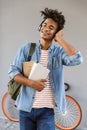 Happy young african man with backpack outdoors Royalty Free Stock Photo