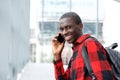 Happy young african man talking on cell phone Royalty Free Stock Photo