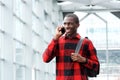 Happy young african man talking on phone outdoors Royalty Free Stock Photo